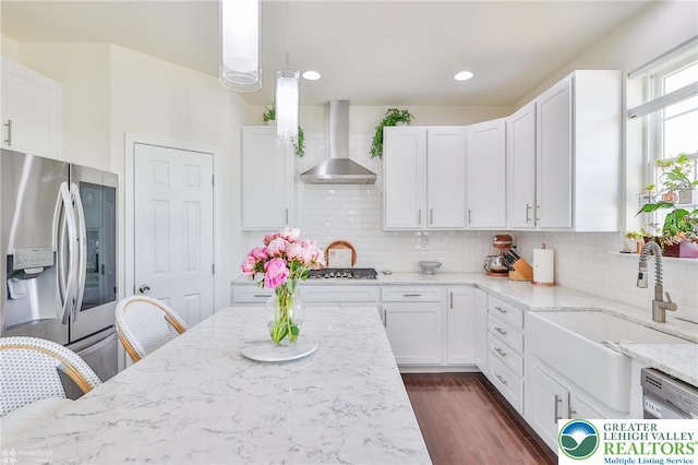 249 Danbury Dr, Upper Nazareth Twp, PA 18064 - kitchen featuring stainless steel refrigerator with ice dispenser, light stone counters, wall chimney range hood, white cabinets, and recessed lighting