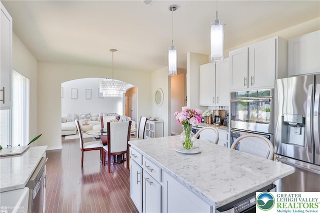 249 Danbury Dr, Upper Nazareth Twp, PA 18064 - kitchen with arched walkways, a center island, appliances with stainless steel finishes, and white cabinetry