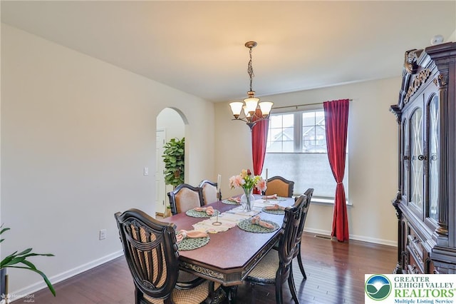 249 Danbury Dr, Upper Nazareth Twp, PA 18064 - dining space with arched walkways, a chandelier, and wood finished floors