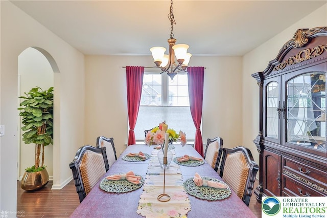 249 Danbury Dr, Upper Nazareth Twp, PA 18064 - dining room with a chandelier, arched walkways, and wood finished floors