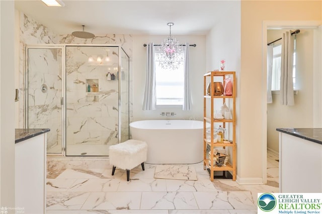 249 Danbury Dr, Upper Nazareth Twp, PA 18064 - bathroom featuring a marble finish shower, marble look tiles, a soaking tub, and vanity