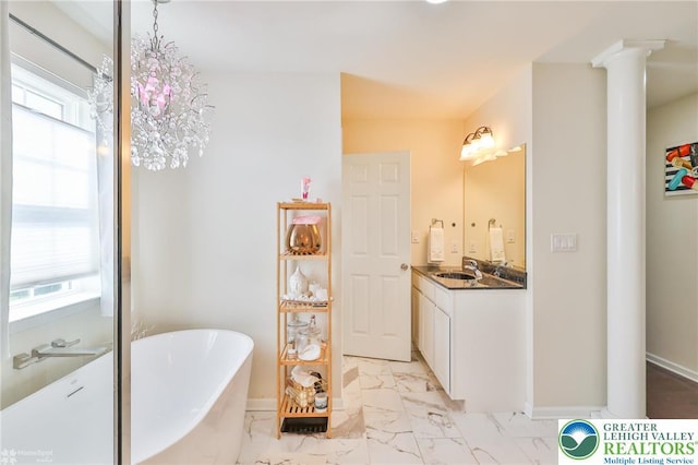 249 Danbury Dr, Upper Nazareth Twp, PA 18064 - full bathroom featuring ornate columns, a freestanding tub, vanity, and marble look tiles