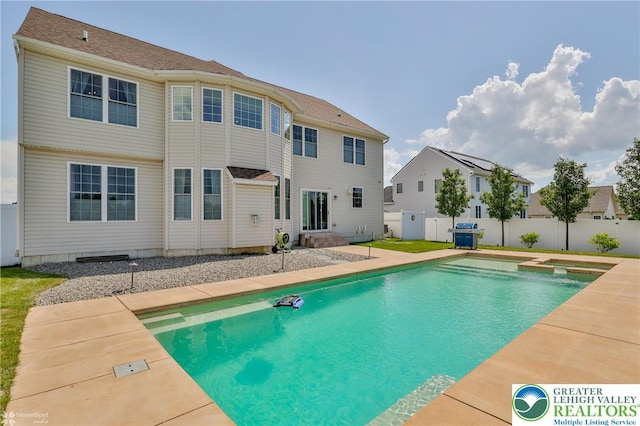249 Danbury Dr, Upper Nazareth Twp, PA 18064 - view of swimming pool featuring a pool with connected hot tub, a patio, entry steps, and a residential view
