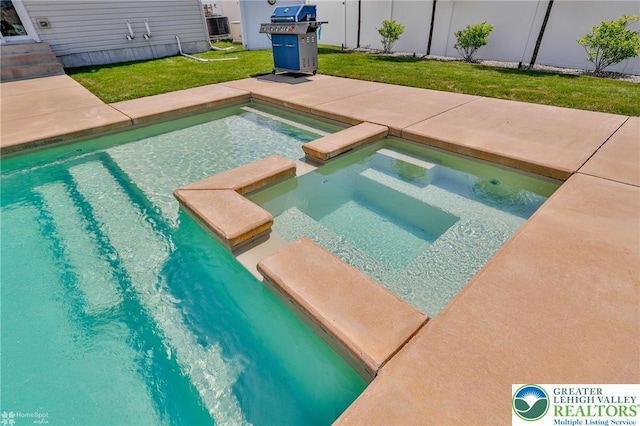 249 Danbury Dr, Upper Nazareth Twp, PA 18064 - view of swimming pool with a grill, a lawn, and a pool with connected hot tub