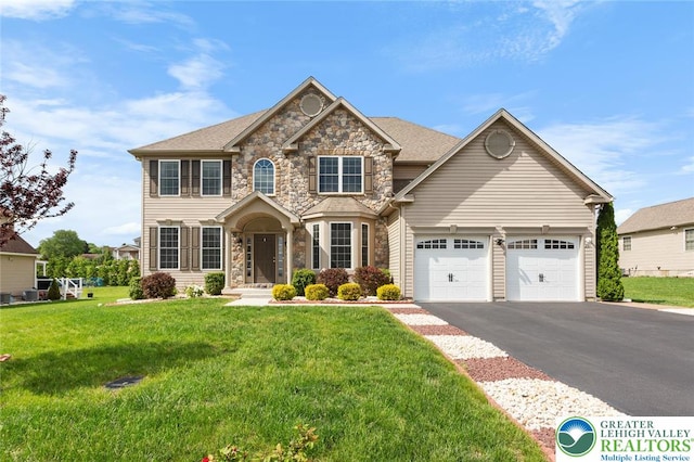237 Danbury Dr, Upper Nazareth Twp, PA 18064 - view of front of home featuring stone siding, an attached garage, asphalt driveway, and a front lawn