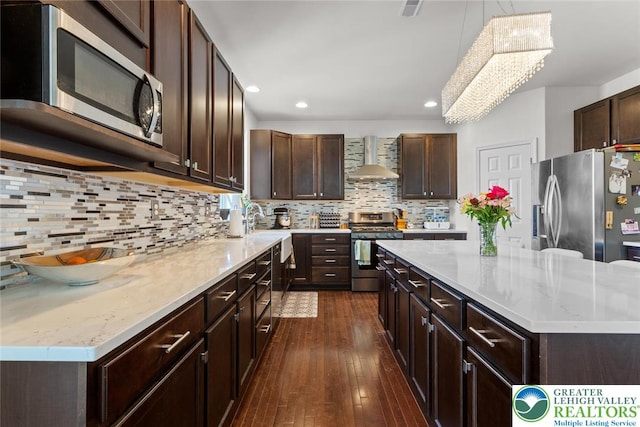237 Danbury Dr, Upper Nazareth Twp, PA 18064 - kitchen with stainless steel appliances, wall chimney range hood, dark wood-style floors, dark brown cabinets, and recessed lighting