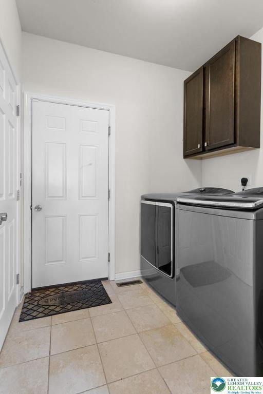 237 Danbury Dr, Upper Nazareth Twp, PA 18064 - washroom featuring cabinet space, independent washer and dryer, and light tile patterned floors