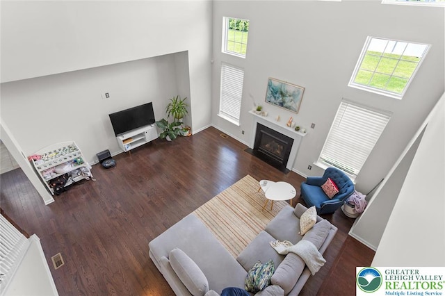 237 Danbury Dr, Upper Nazareth Twp, PA 18064 - living room with a high ceiling, plenty of natural light, wood finished floors, and a fireplace with flush hearth