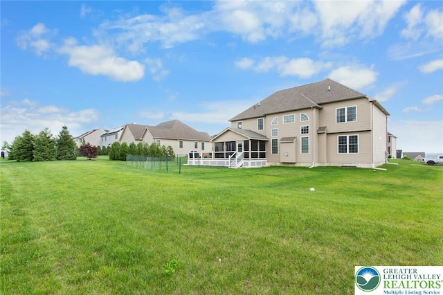 237 Danbury Dr, Upper Nazareth Twp, PA 18064 - back of house featuring a sunroom and a lawn