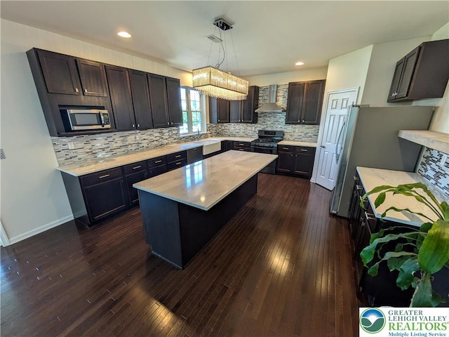 237 Danbury Dr, Upper Nazareth Twp, PA 18064 - kitchen with stainless steel appliances, a kitchen island, backsplash, dark wood-type flooring, and recessed lighting