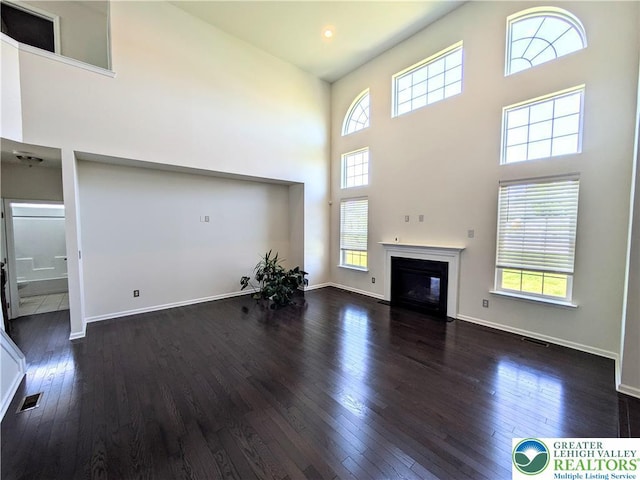 237 Danbury Dr, Upper Nazareth Twp, PA 18064 - unfurnished living room featuring a high ceiling, wood-type flooring, and healthy amount of natural light
