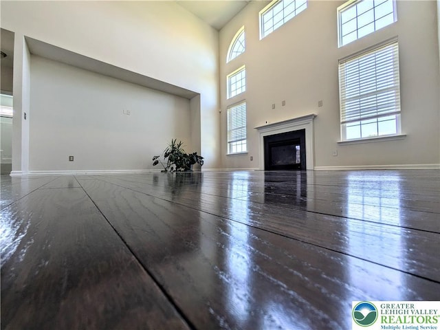 237 Danbury Dr, Upper Nazareth Twp, PA 18064 - unfurnished living room with healthy amount of natural light, wood finished floors, a fireplace, and a high ceiling