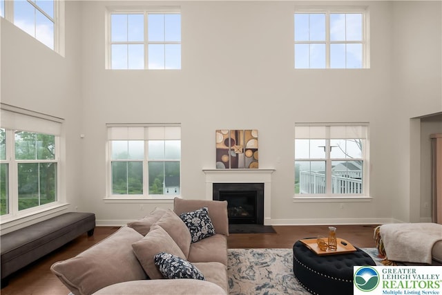 5635 Saucon Ridge Rd, Upper Saucon Twp, PA 18036 - living room with a towering ceiling, healthy amount of natural light, a fireplace with flush hearth, and wood finished floors