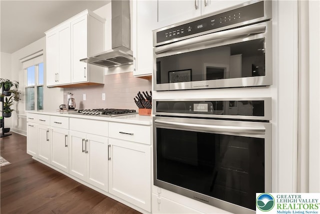 5635 Saucon Ridge Rd, Upper Saucon Twp, PA 18036 - kitchen with wall chimney range hood, stainless steel appliances, light countertops, white cabinetry, and tasteful backsplash