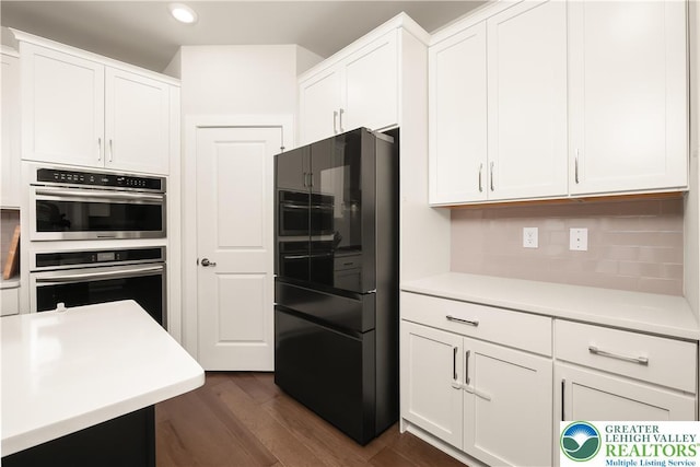 5635 Saucon Ridge Rd, Upper Saucon Twp, PA 18036 - kitchen featuring freestanding refrigerator, light countertops, dark wood-style floors, white cabinets, and double oven