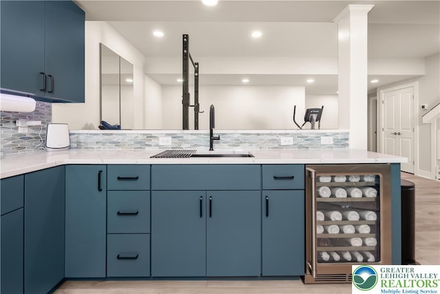 5635 Saucon Ridge Rd, Upper Saucon Twp, PA 18036 - kitchen with beverage cooler, blue cabinets, tasteful backsplash, recessed lighting, and light wood finished floors