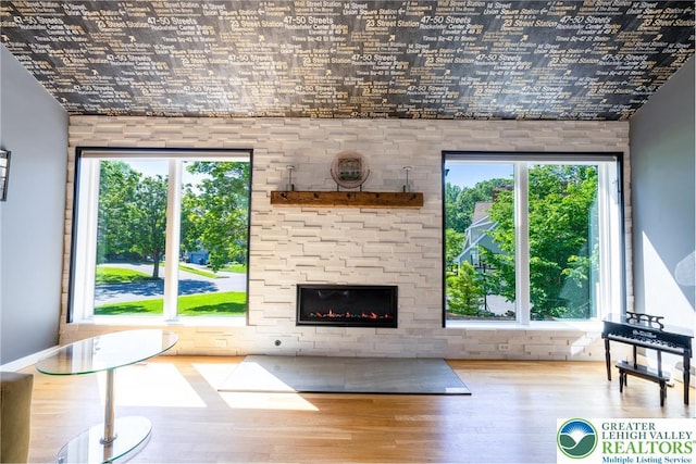 1488 Shelburne Ct, South Whitehall Twp, PA 18104 - living room featuring wood finished floors, a large fireplace, and healthy amount of natural light