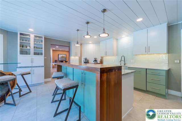 1488 Shelburne Ct, South Whitehall Twp, PA 18104 - kitchen with dishwasher, white cabinetry, recessed lighting, light tile patterned floors, and a center island