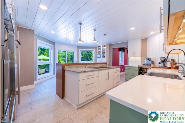 1488 Shelburne Ct, South Whitehall Twp, PA 18104 - kitchen with black electric stovetop, a kitchen island, white cabinetry, recessed lighting, and light tile patterned flooring