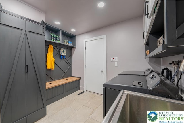 1488 Shelburne Ct, South Whitehall Twp, PA 18104 - laundry room with separate washer and dryer, a barn door, recessed lighting, light tile patterned flooring, and cabinet space
