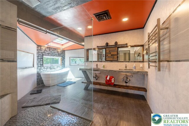 1488 Shelburne Ct, South Whitehall Twp, PA 18104 - full bath featuring tile walls, a towel warmer, a soaking tub, double vanity, and a shower