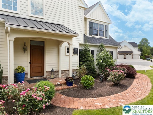 2063 Forge Run, Bethlehem City, PA 18015 - view of front facade featuring a standing seam roof, roof with shingles, concrete driveway, and a metal roof