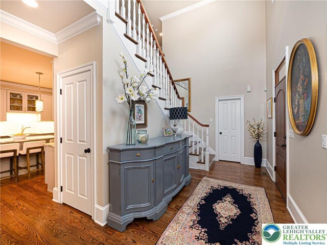 2063 Forge Run, Bethlehem City, PA 18015 - foyer entrance with stairs, dark wood-style floors, ornamental molding, and a high ceiling