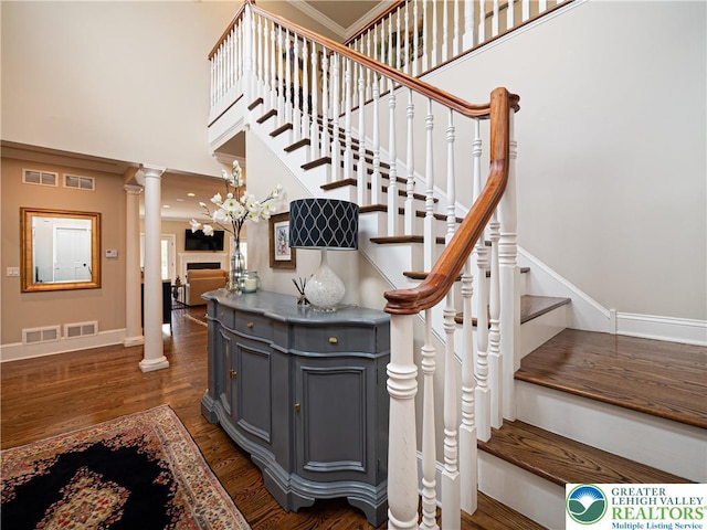 2063 Forge Run, Bethlehem City, PA 18015 - staircase with decorative columns, a high ceiling, wood finished floors, and ornamental molding