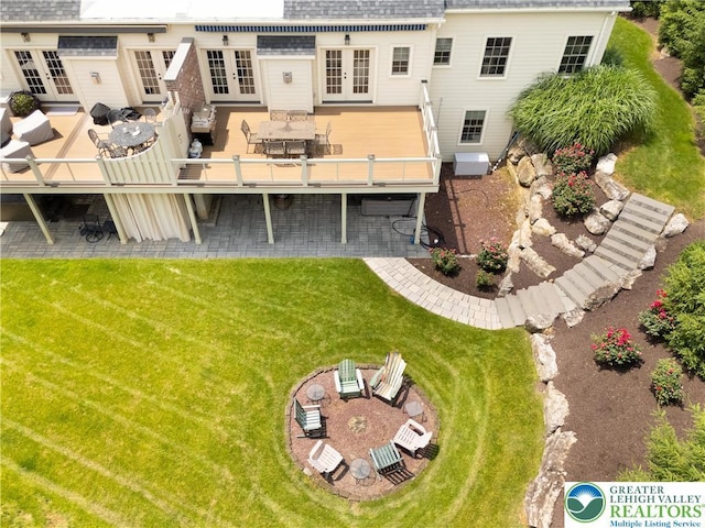 2063 Forge Run, Bethlehem City, PA 18015 - back of house featuring french doors, outdoor dining space, a lawn, roof with shingles, and a deck