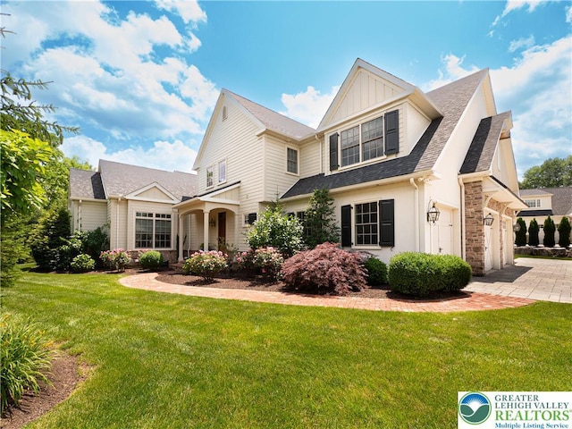2063 Forge Run, Bethlehem City, PA 18015 - view of front of property featuring stone siding, a front lawn, driveway, and board and batten siding