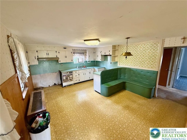 1818 W Jane St, South Whitehall Twp, PA 18104 - kitchen featuring open shelves, white cabinetry, light countertops, wallpapered walls, and light flooring