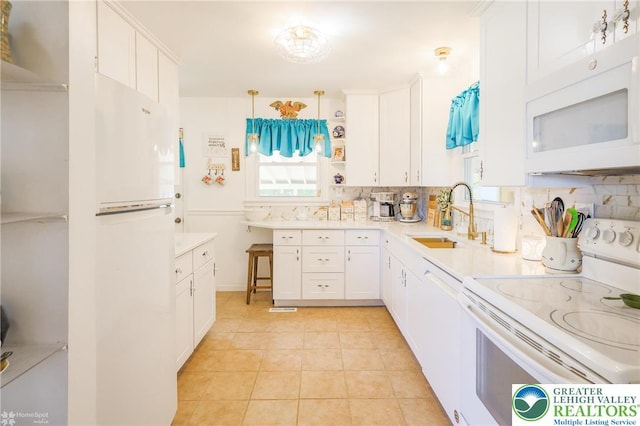4306 Emerick Ter, Easton, PA 18045 - kitchen featuring white appliances, healthy amount of natural light, backsplash, and white cabinetry