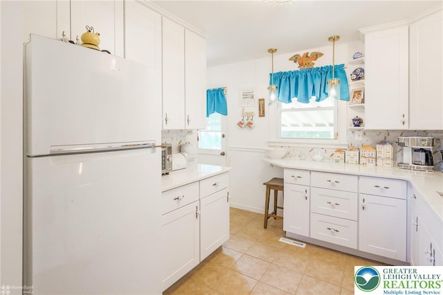 4306 Emerick Ter, Easton, PA 18045 - kitchen with freestanding refrigerator, decorative backsplash, white cabinets, and light countertops