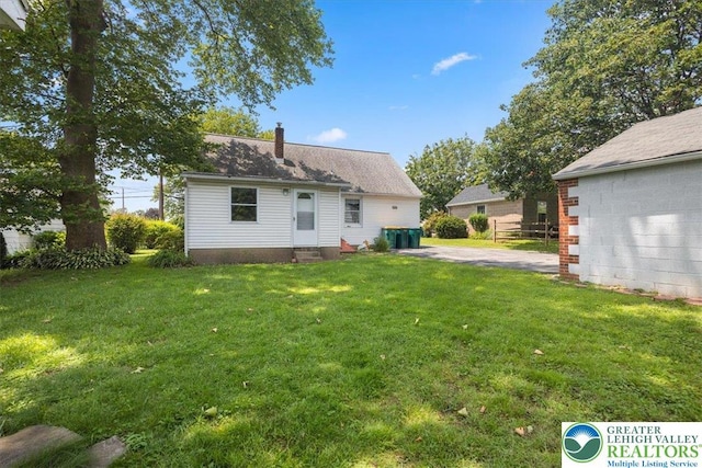 803 Stones Crossing Rd, Palmer Twp, PA 18045 - back of property featuring entry steps, a yard, and a chimney