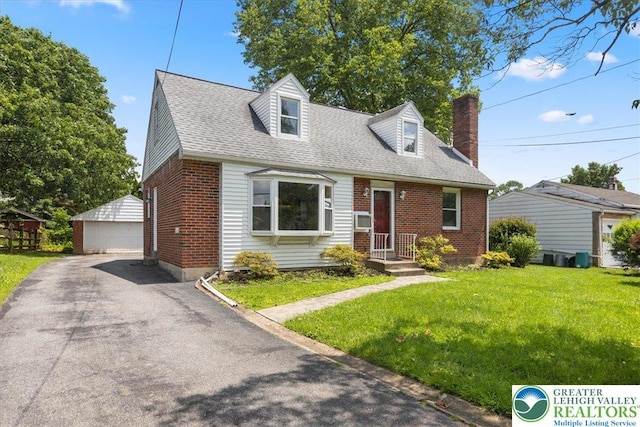 803 Stones Crossing Rd, Palmer Twp, PA 18045 - cape cod house featuring brick siding, an outdoor structure, a chimney, a detached garage, and a front lawn