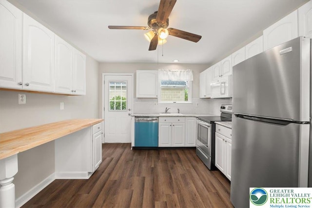 803 Stones Crossing Rd, Palmer Twp, PA 18045 - kitchen with appliances with stainless steel finishes, butcher block countertops, dark wood-type flooring, a ceiling fan, and white cabinetry