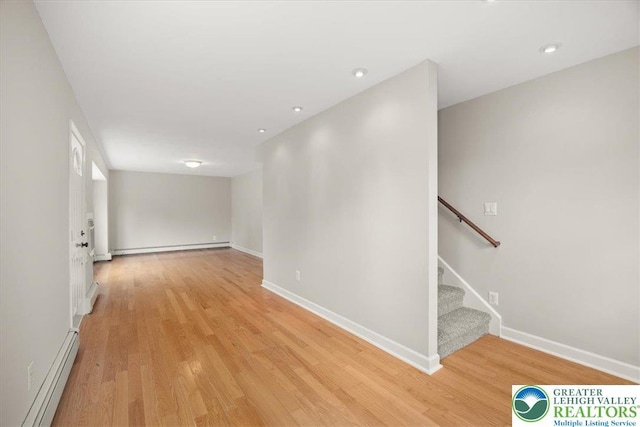 803 Stones Crossing Rd, Palmer Twp, PA 18045 - empty room with a baseboard heating unit, light wood-style floors, stairs, and recessed lighting
