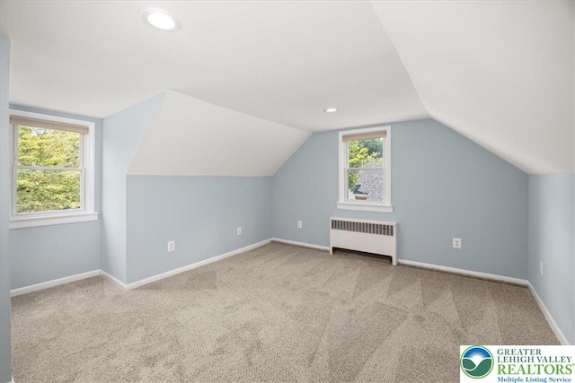 803 Stones Crossing Rd, Palmer Twp, PA 18045 - additional living space with radiator, carpet floors, vaulted ceiling, and recessed lighting