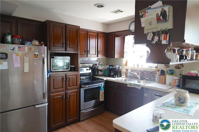 871 2nd St, Whitehall Twp, PA 18052 - kitchen with stainless steel appliances, light countertops, under cabinet range hood, and light wood-style floors