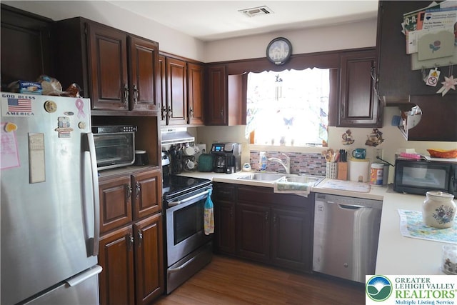 871 2nd St, Whitehall Twp, PA 18052 - kitchen with stainless steel appliances, light countertops, under cabinet range hood, and dark brown cabinetry