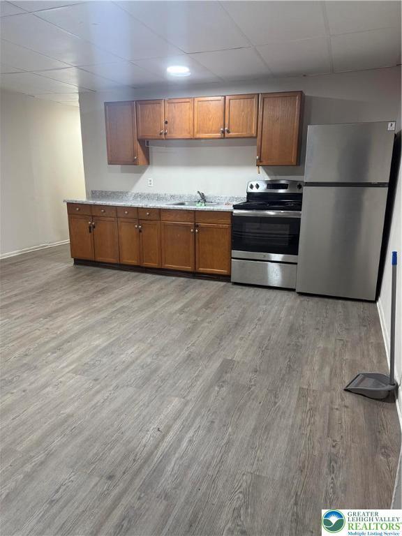 539 Atlantic Unit 3, Bethlehem Twp, PA 18015 - kitchen featuring stainless steel appliances, light wood-type flooring, and brown cabinetry