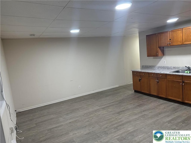 539 Atlantic Unit 3, Bethlehem Twp, PA 18015 - kitchen featuring a paneled ceiling, wood finished floors, brown cabinets, and light countertops