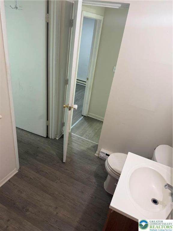 539 Atlantic Unit 3, Bethlehem Twp, PA 18015 - bathroom featuring wood finished floors, a baseboard heating unit, and vanity