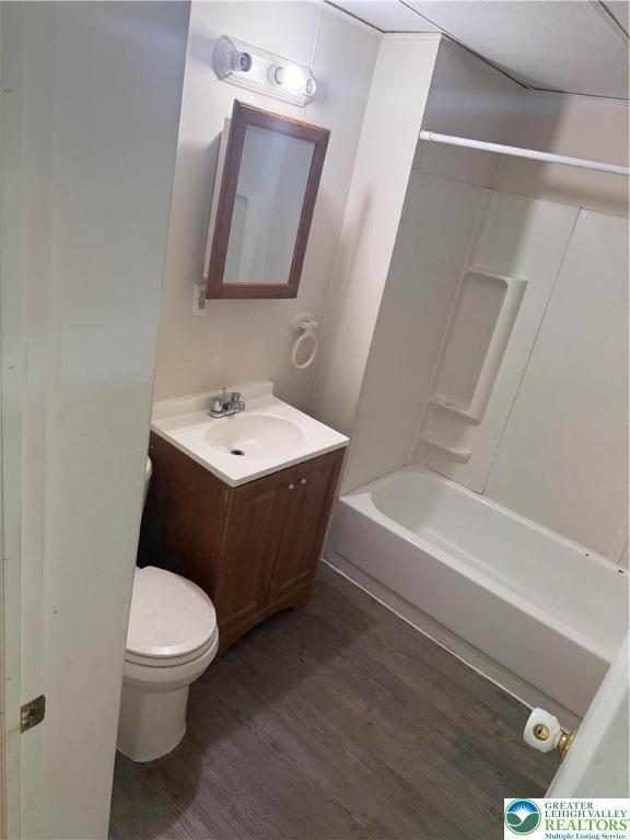539 Atlantic Unit 3, Bethlehem Twp, PA 18015 - bathroom featuring vanity, wood finished floors, and washtub / shower combination