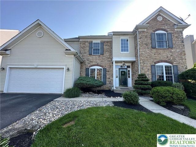 1989 Strathmore Dr, Macungie Boro, PA 18062 - view of front of house with stone siding, driveway, and an attached garage