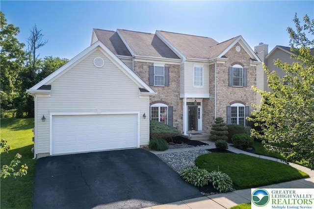 1989 Strathmore Dr, Macungie Boro, PA 18062 - view of front of house with stone siding, driveway, and a front yard