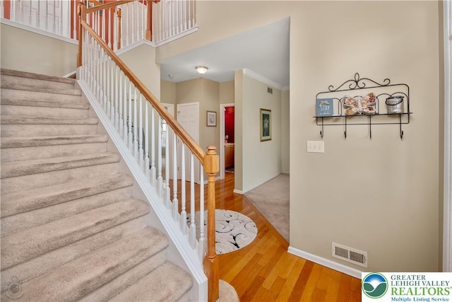 1989 Strathmore Dr, Macungie Boro, PA 18062 - stairs with wood finished floors and ornamental molding