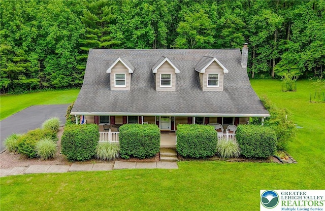 142 Hickory Ln, Chestnuthill Twp, PA 18353 - new england style home with a porch, a front lawn, a chimney, and roof with shingles