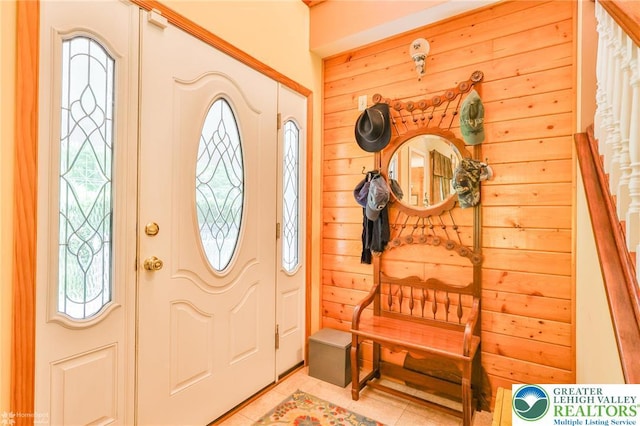 142 Hickory Ln, Chestnuthill Twp, PA 18353 - entrance foyer featuring stairs, light tile patterned flooring, and wooden walls