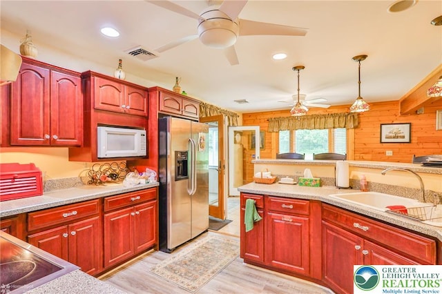 142 Hickory Ln, Chestnuthill Twp, PA 18353 - kitchen featuring stainless steel fridge, white microwave, a ceiling fan, dark brown cabinets, and wood walls